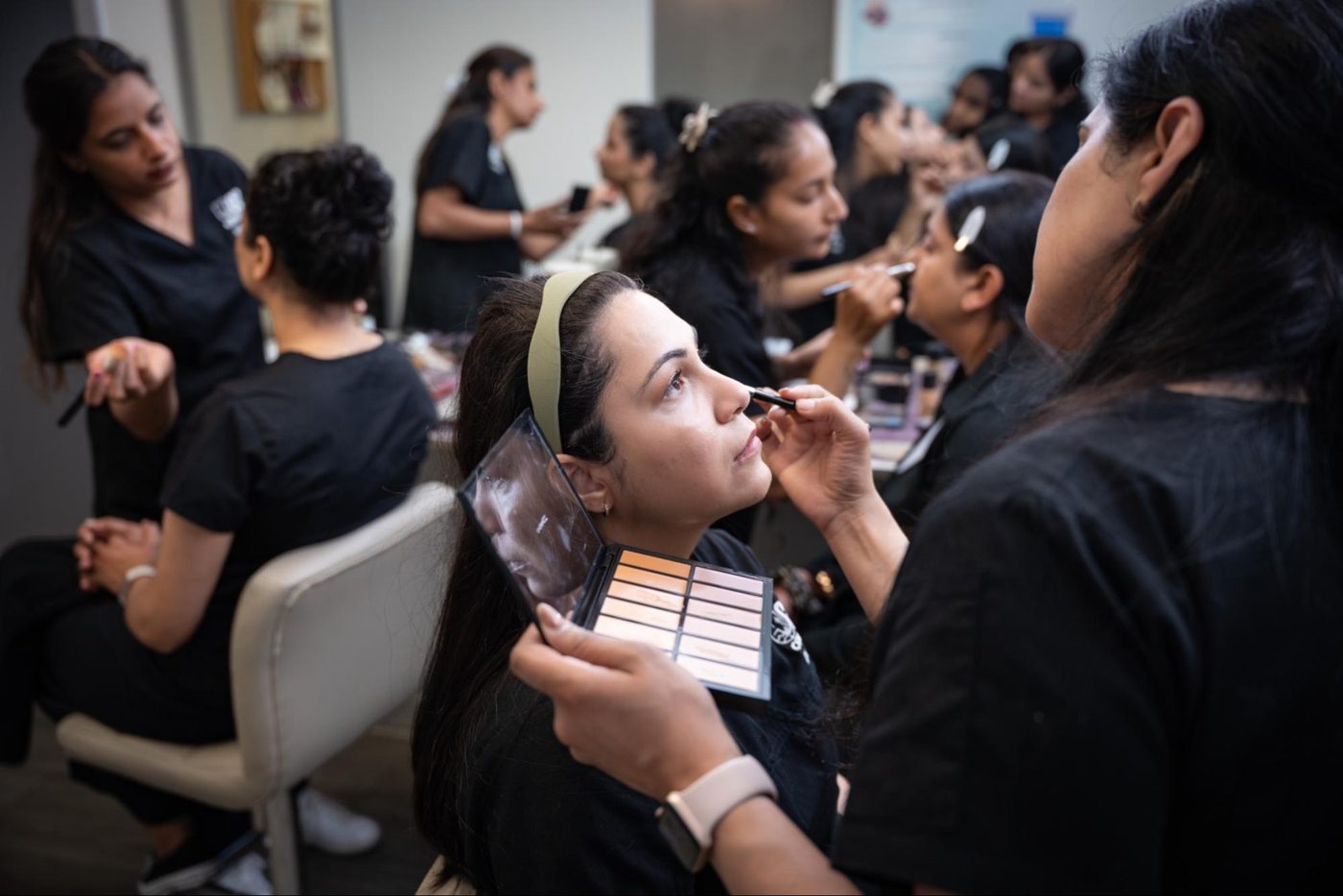 GD College makeup artistry students practicing on models in class